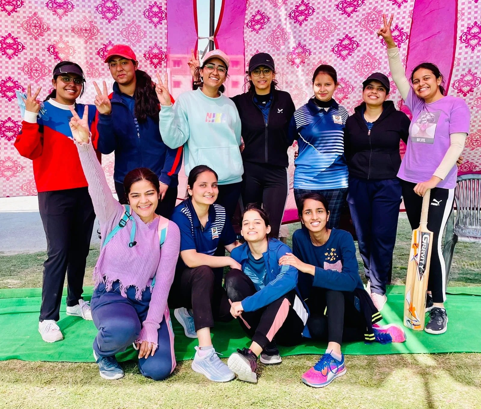 eleven female with cricket bat